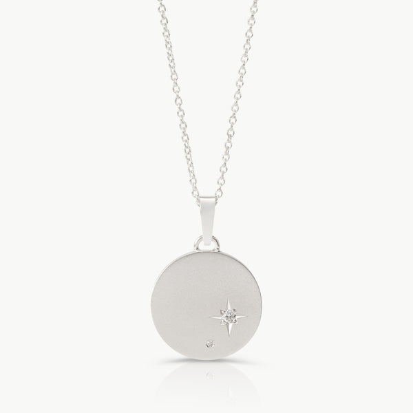 Inspired by starry skies – A disc pendant in sterling silver set with 2 lab-grown diamonds in an engraved setting expertly hand crafted by artisans in Cape Town.