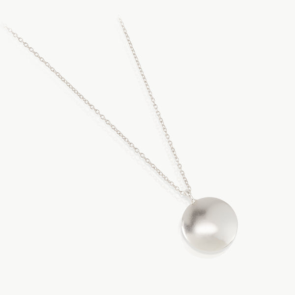 Sustainable silver necklace with a handmade round pebble pendant