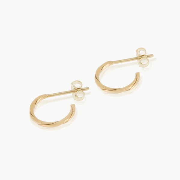 Two 9 karat gold strands twisted together to form a small hoop earring. Handmade in our well-established fine jewellery design studio in Cape Town.