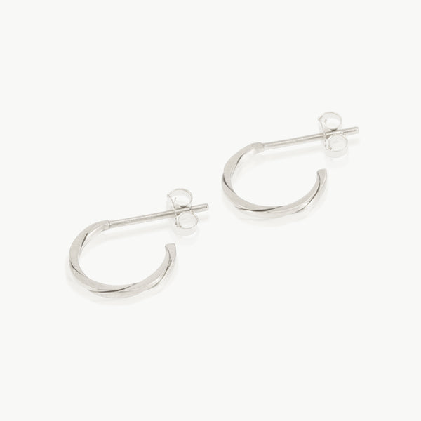 Two sterling silver strands twisted together to form a small hoop earring. Handmade in our well-established fine jewellery design studio in Cape Town.