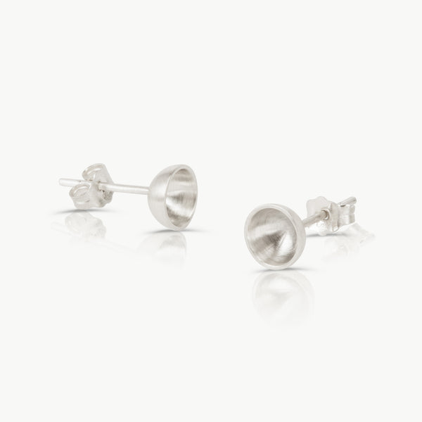 Found in The Old Biscuit Mill, our independent studio handcrafts stud earrings in sterling silver shaped as a small open vessel.