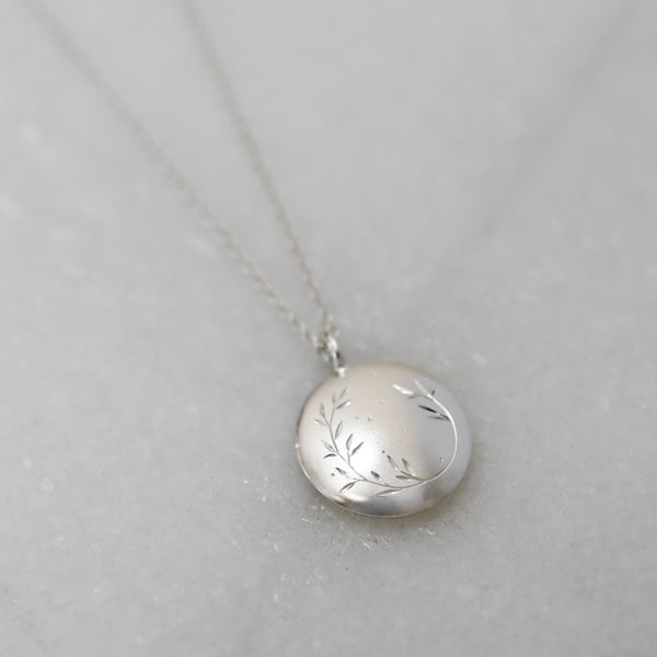 Round sterling silver pendant handcrafted in ethically sourced, eco-friendly silver with a hand-engraved wreath design.