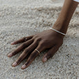 Woman wearing an ethical gold ring. This minimalist Line Ring is handmade in Cape Town in recycled gold from e-waste.