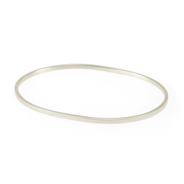 A simple, narrow, oval bangle hand fashioned from Fairmined sterling silver in our manufacturing studio in The Old Biscuit Mill, Cape Town, South Africa.