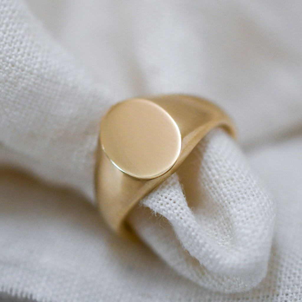 Modern ethical gold signet ring, crafted with responsibly sourced 9K yellow gold.