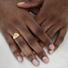 Eco-friendly gold signet ring on man's hand, bold and sustainable statement jewellery. Engravable.