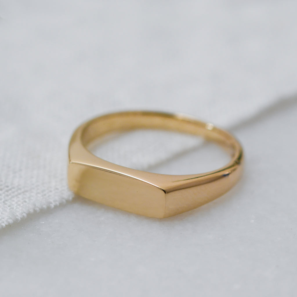 Sustainable luxury 9K gold signet ring, handmade from eco-friendly materials.