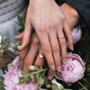 Flat Band wedding ring on Man's hand in Fairmined ethical gold