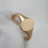 Sustainable oval dainty signet ring in yellow gold, eco-conscious fine jewelry