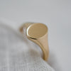 Eco-conscious dainty 9K yellow gold signet ring, timeless and sustainably crafted.