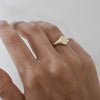 Dainty ethical gold oval signet ring handcrafted from Fairmined eco-friendly gold on woman's hand