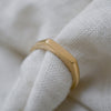 Eco-friendly dainty gold signet ring, ethically crafted with a slim profile.