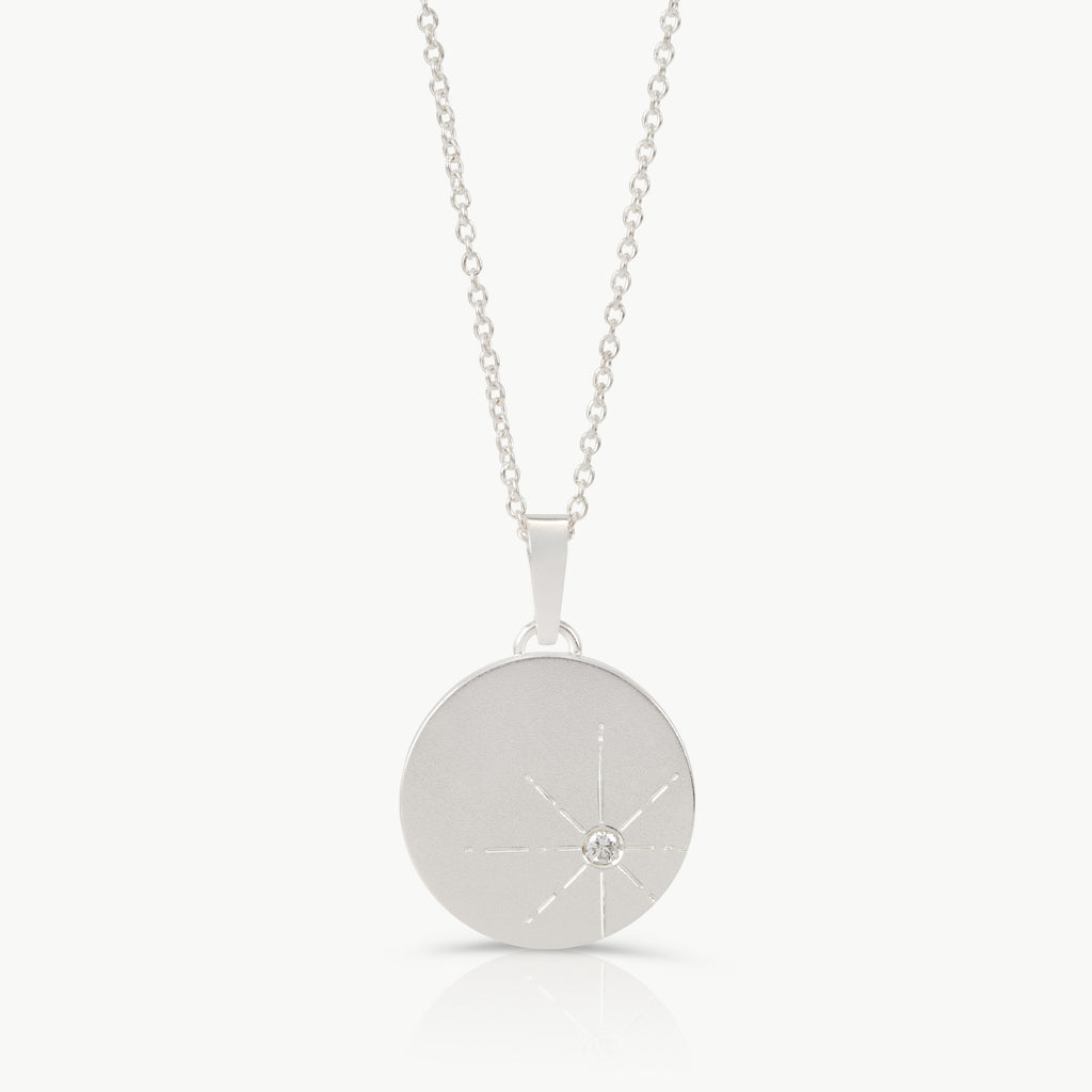 Sterling silver necklace with a round pendant set with a lab grown diamond and engraved
