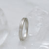 Fairmined certified silver ring on a textured white surface