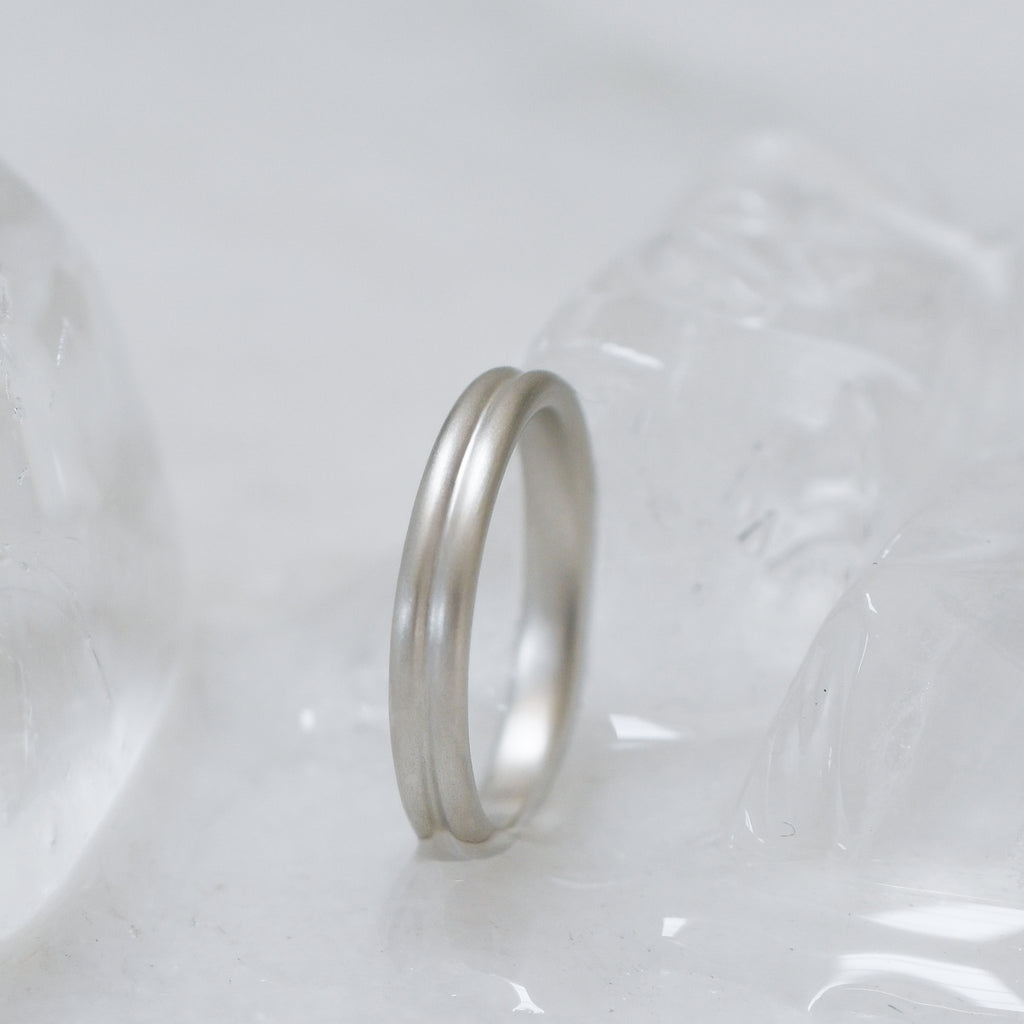 Fairmined certified silver ring on a textured white surface