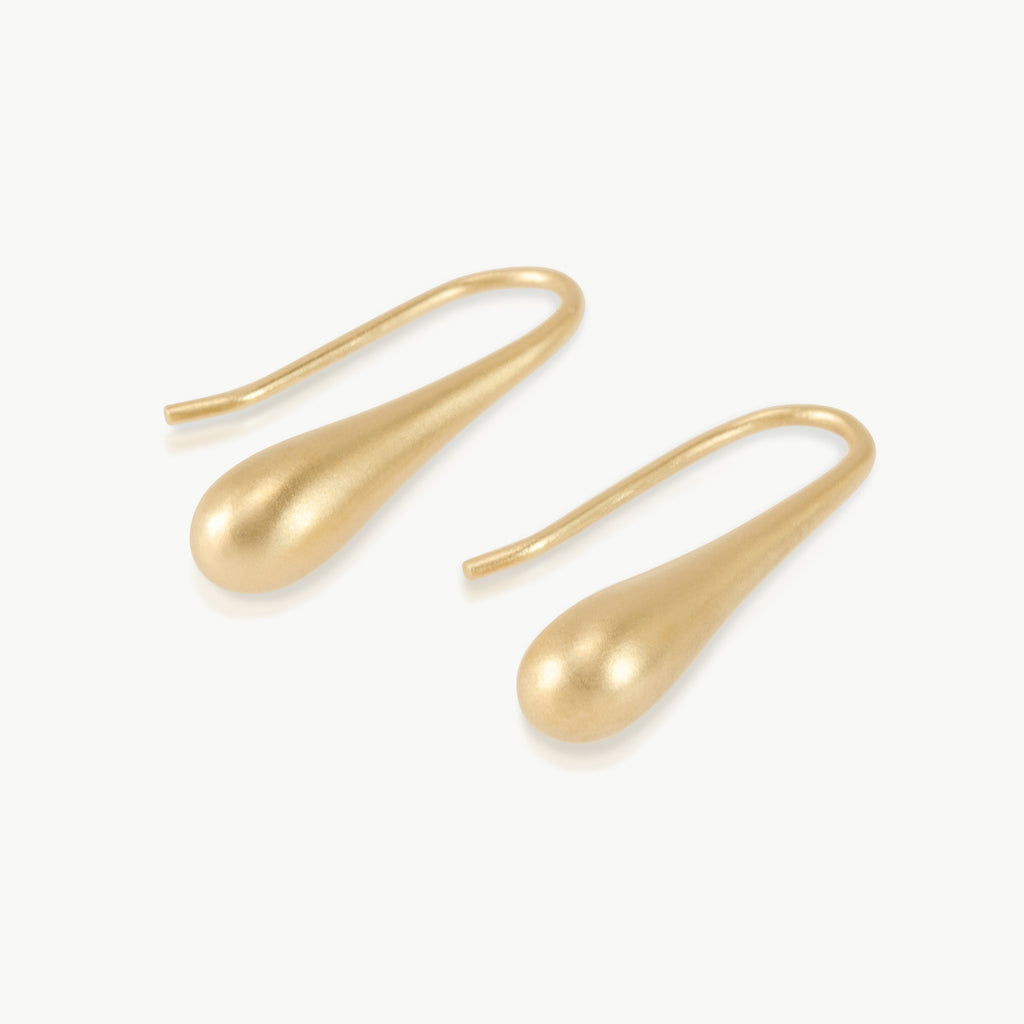 Imagine an extended water droplet about to fall from a leaf, this elongated drop earring design is nature inspired and hand crafted in Cape Town, South Africa in 9K gold.