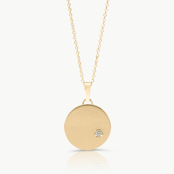 Handcrafted by an independent jeweller in Cape Town – A large disc necklace in solid 9K gold and set with a lab-grown diamond, inspired by the night sky.  