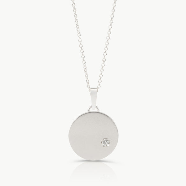 Sterling silver necklace with a round pendant set with a lab grown diamond