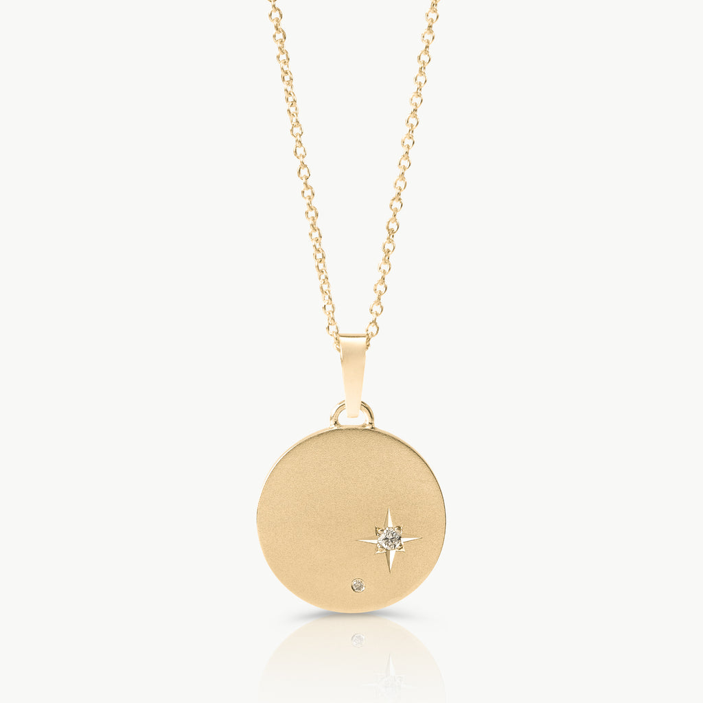 Inspired by starry skies – A disc necklace in solid 9K gold set with 2 lab-grown diamonds in an engraved setting expertly hand crafted by artisans in Cape Town.