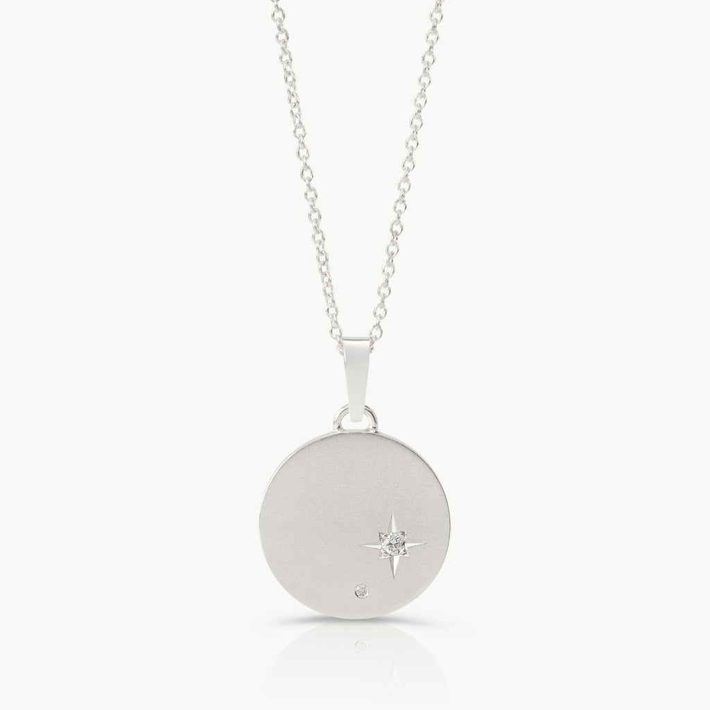 Inspired by starry skies – A disc pendant in sterling silver set with 2 lab-grown diamonds in an engraved setting expertly hand crafted by artisans in Cape Town.