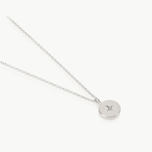 Sterling silver necklace with a round pendant set with a lab grown 