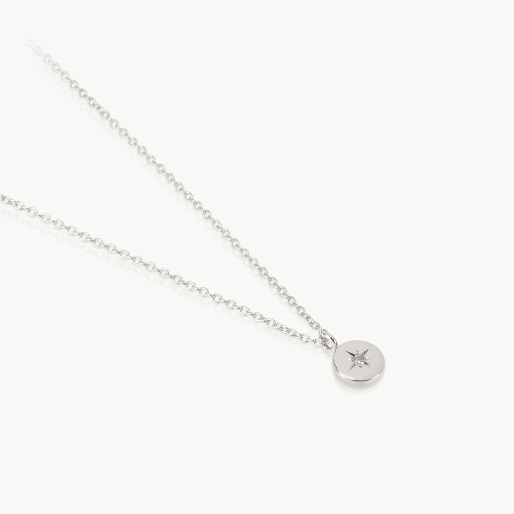 Earth inspired simple pendant – The tiny disc charm handmade in Cape Town from ethically mined sterling silver, is set with a lab-grown diamond.
