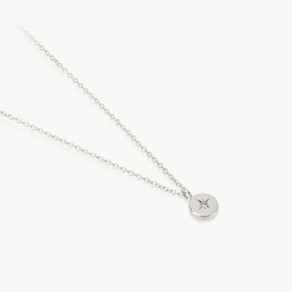 Sterling silver necklace with a small disc pendant set with a lab grown diamond