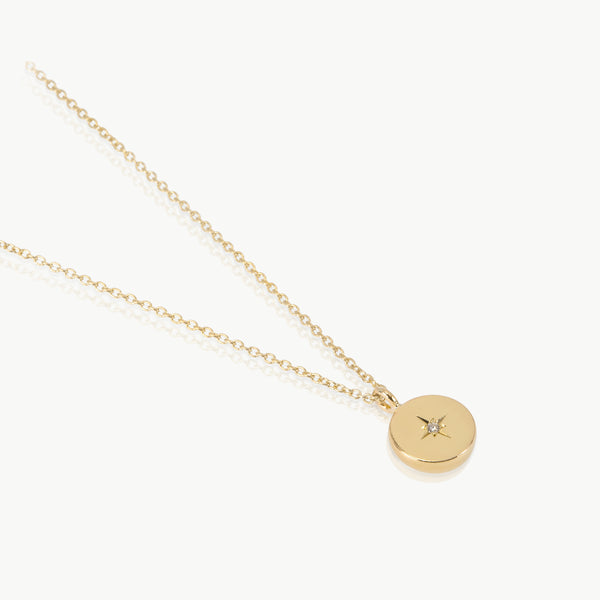 Solar system inspired – The small disc charm on a chain is handmade in Cape Town from Fairmined certified 9K gold and set with a lab-grown diamond.