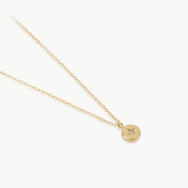 Earth inspired simple pendant – The tiny disc charm handmade in Cape Town from ethically mined 9K gold, is set with a lab-grown diamond.