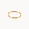 Simple gold band with engraved line texture, contemporary minimalist jewellery style in eco-friendly Fairmined gold.