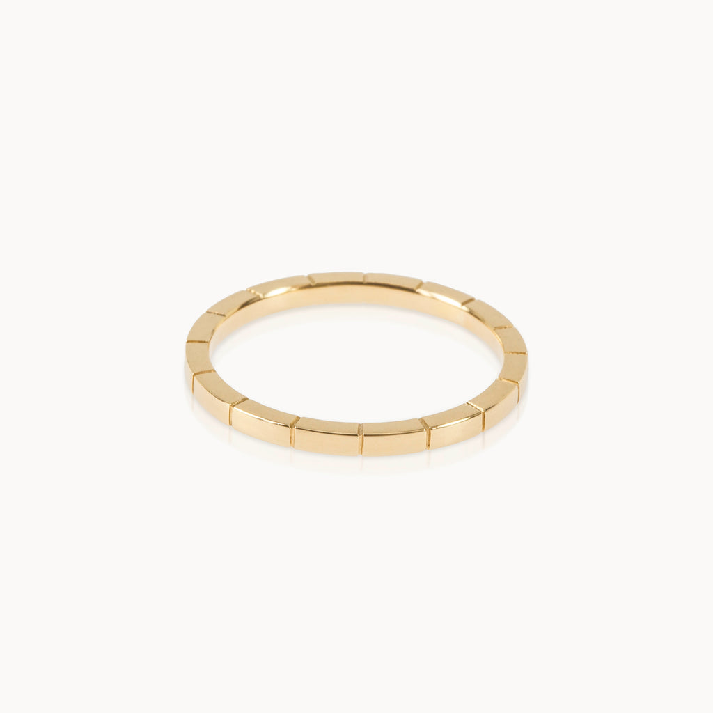 Simple gold band with engraved line texture, contemporary minimalist jewellery style in eco-friendly Fairmined gold.