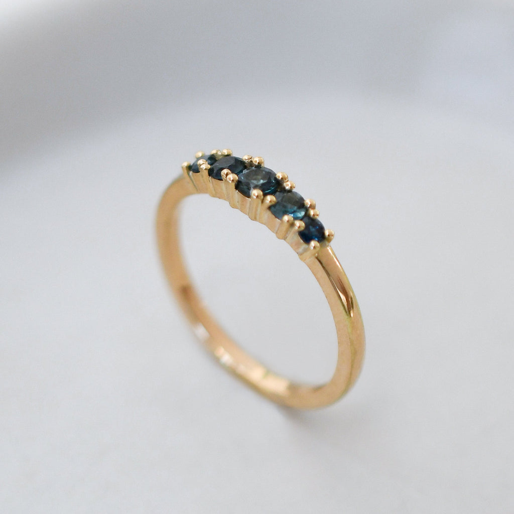 Blue sapphire ring with five graduated stones set in a Fairmined gold band