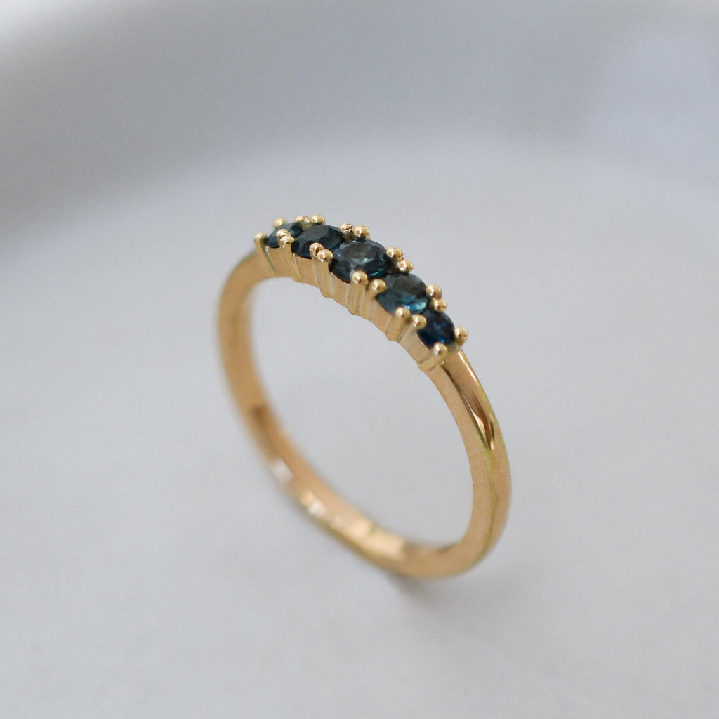 Blue sapphire ring with five graduated stones set in a Fairmined gold band