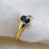 Sustainable jewellery — yellow gold ring with one deep blue sapphire and tapered band
