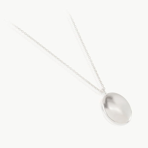 A timeless piece - An oval sterling silver pebble pendant inspired by the earth, created in our established independent studio in the Old Biscuit Mill, Cape Town. 