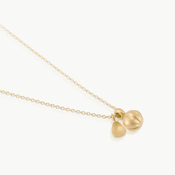 Botanical inspired – A pendant with 2 charms, a seed and a leaf, expertly hand crafted in ethically mined solid 9K gold in Cape Town, South Africa.
