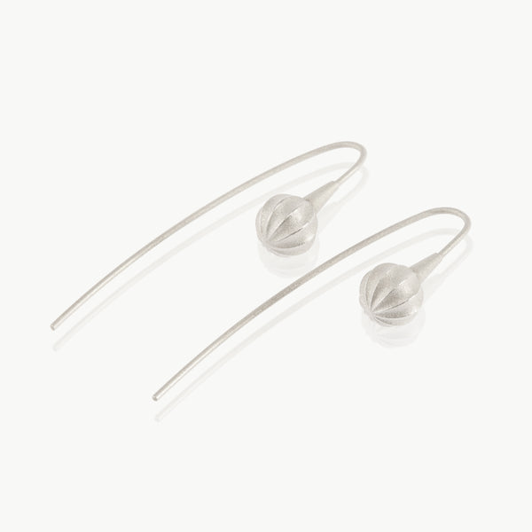 A minimalist seed at the end of a wire drop earring expertly handmade in sterling silver in our well-established fine jewellery design studio in Cape Town.