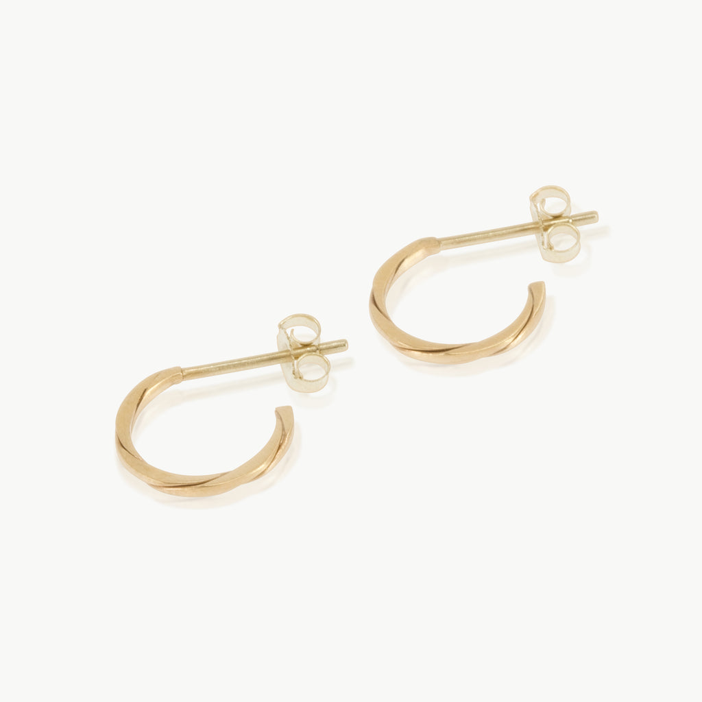 Two 9 karat gold strands twisted together to form a small hoop earring. Handmade in our well-established fine jewellery design studio in Cape Town.