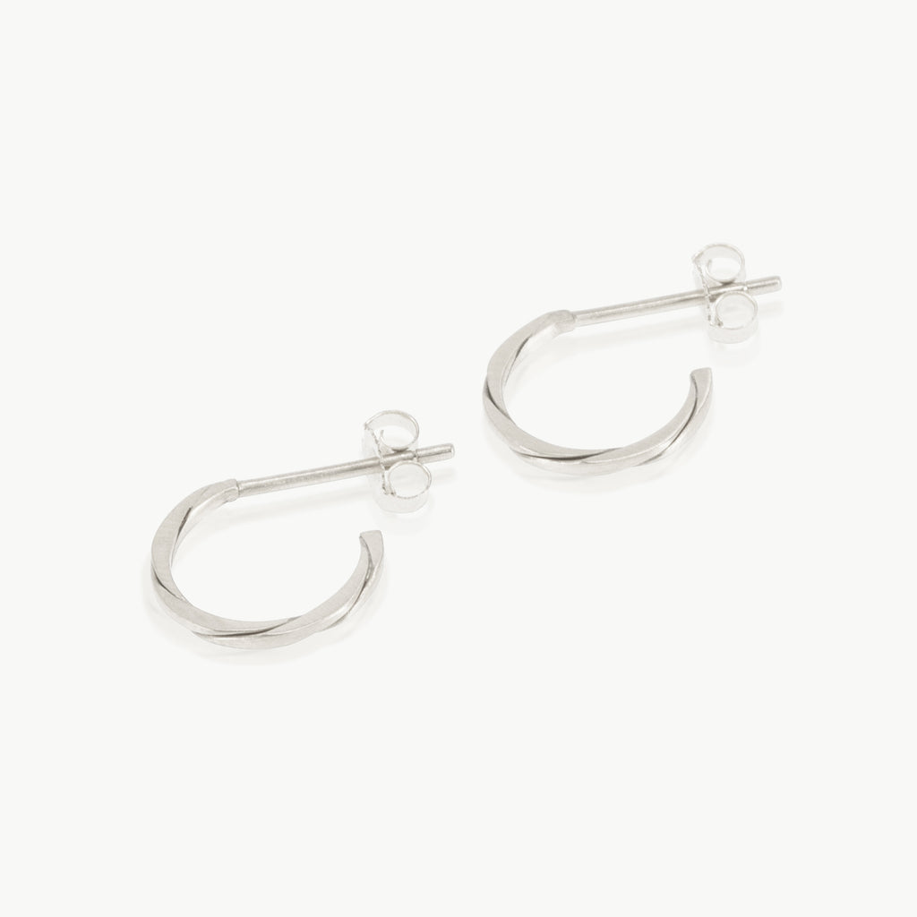 Two sterling silver strands twisted together to form a small hoop earring. Handmade in our well-established fine jewellery design studio in Cape Town.