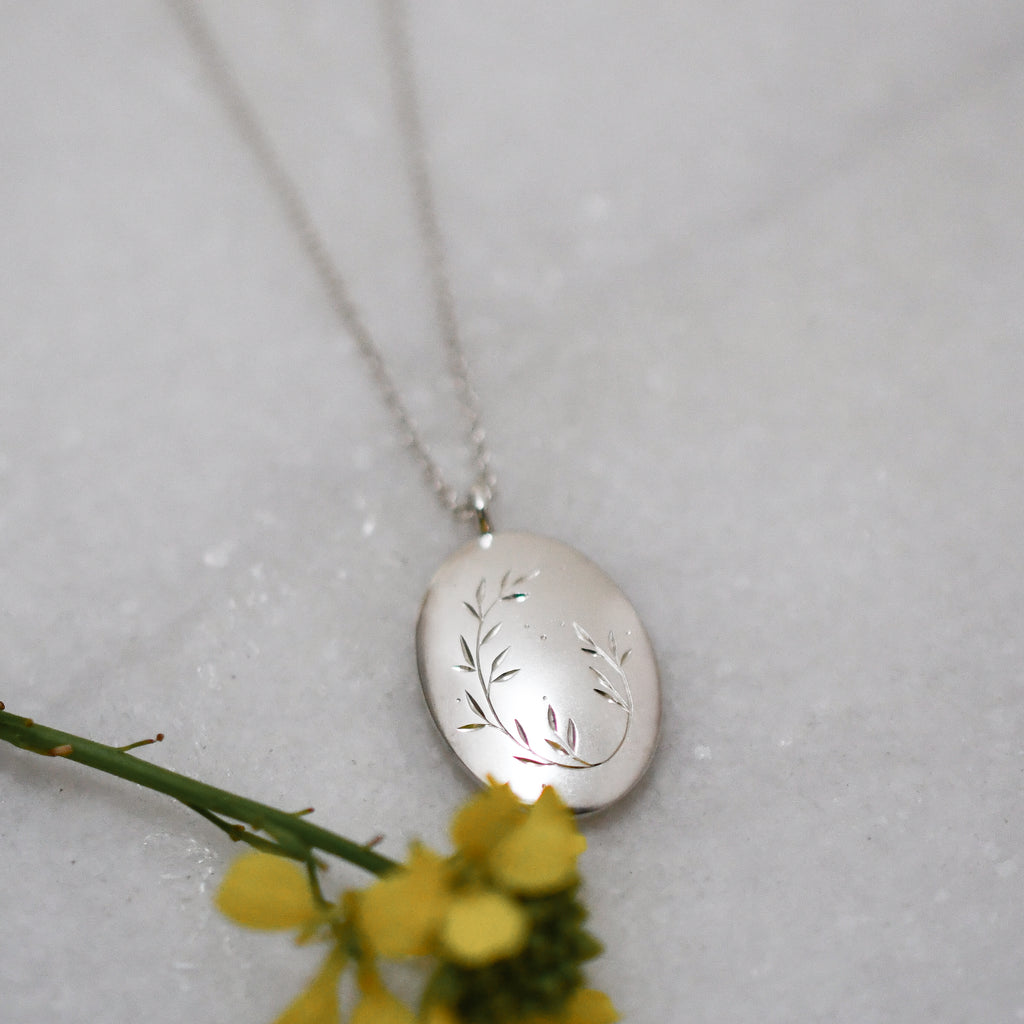 Limited edition sterling silver pendant with hand-engraved wreath design on a 50cm silver chain, handcrafted in Cape Town.