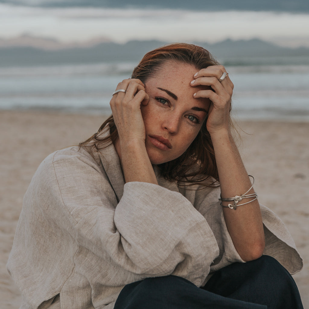 Woman wearing ethical silver bracelet. This minimalist Dancer’s Bangle is handmade in Cape Town in recycled silver from e-waste.