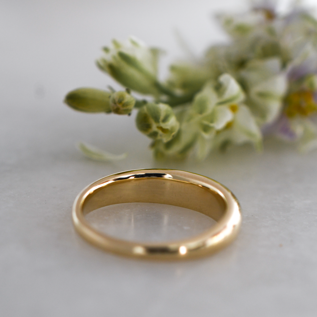 Back view of our sustainably sourced, minimalist 9K gold band.