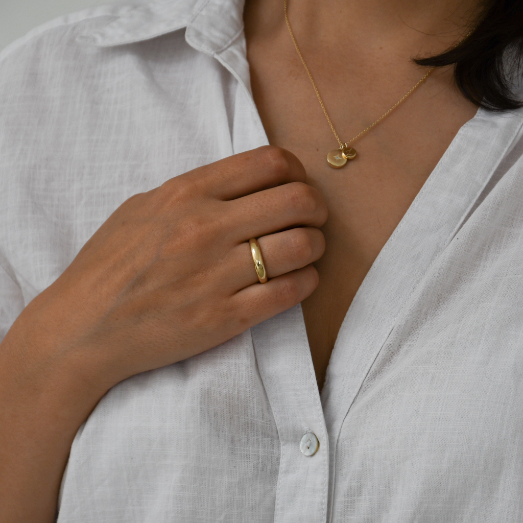 Woman wearing the 9K ethical gold band.