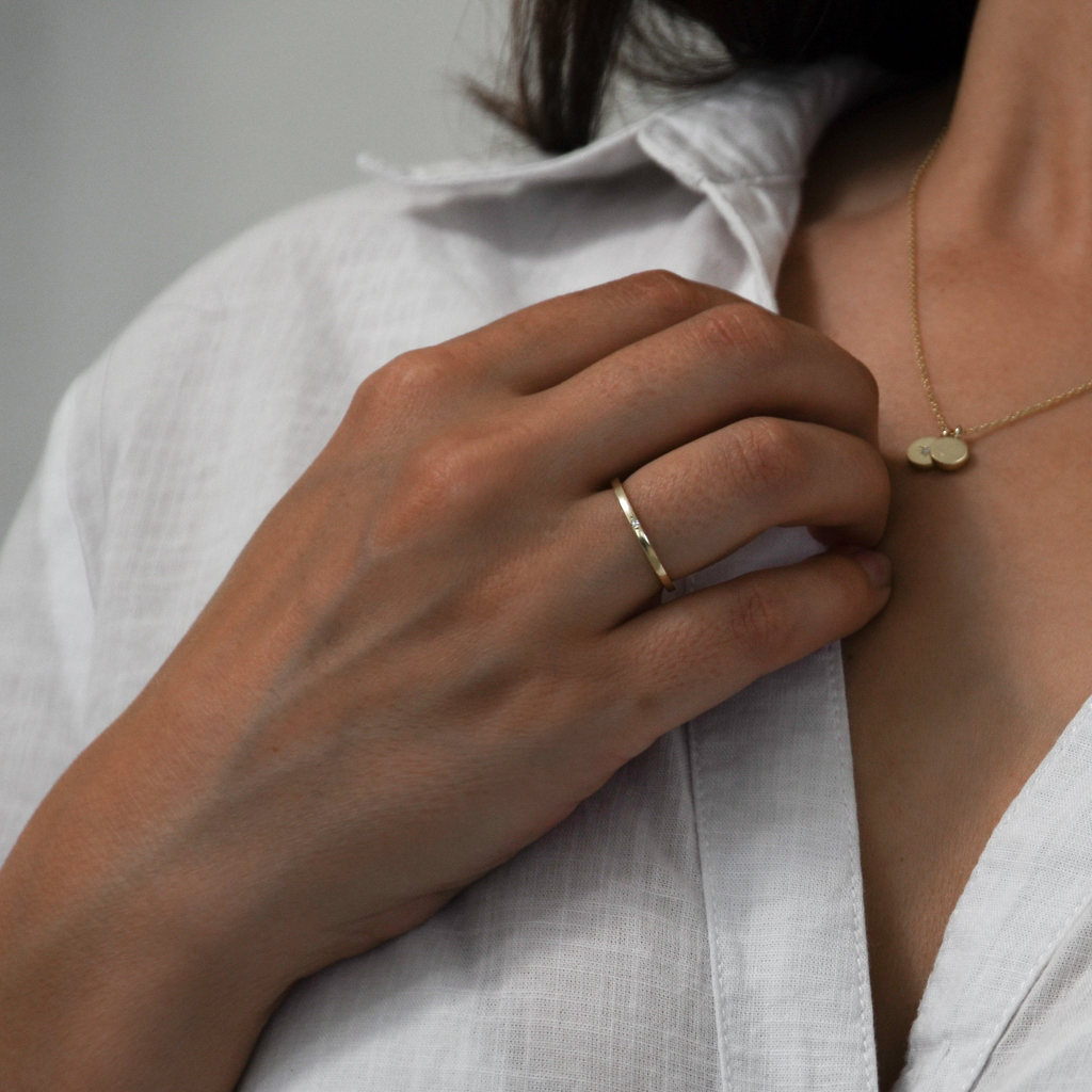 Dew 9K gold ring with lab-grown diamond worn on a woman's hand.