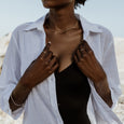 Woman wearing an ethical gold ring. This minimalist Flat Top Ring is handmade in Cape Town in recycled gold from e-waste.