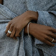 Woman wearing eco-friendly silver bracelet. This sustainable Grassveld Oval Bracelet is handmade in Cape Town in recycled silver from e-waste.