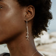 Woman wearing sustainable silver earrings. These artisan crafted Grassveld Earrings are handmade in Cape Town in recycled silver from e-waste.