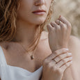 Woman wearing an ethical gold ring. This minimalist Growth Ring is handmade in Cape Town in recycled gold from e-waste.