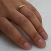 Signet inspired, minimalist eco-friendly Fairmined gold wedding band on a woman's hand.