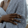 Woman wearing an ethical gold ring. This minimalist Strata Band is handmade in Cape Town in recycled gold from e-waste.
